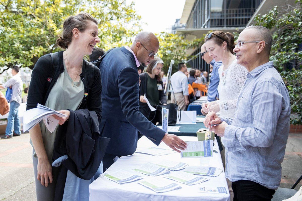 Megan O’Brien, MD, MBE, and Encouse Golden, PhD, are looking at informational booklet about clinical teaching programs available for faculty