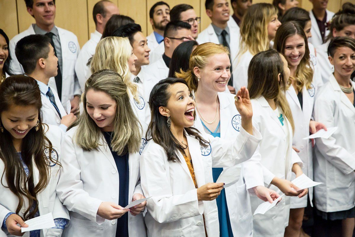 Incoming class for the Department of Physical Therapy and Rehabilitation Science are standing during their white coat ceremony