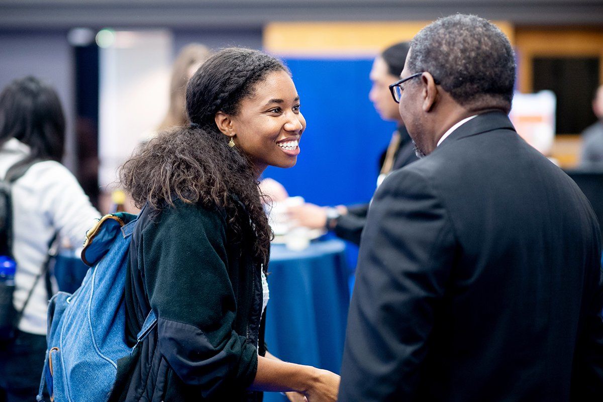 Alexandra Maxey, a first-year medical student, speaks with the UCSF School of Medicine Dean Talmadge E. King Jr., MD, during a reception for new students