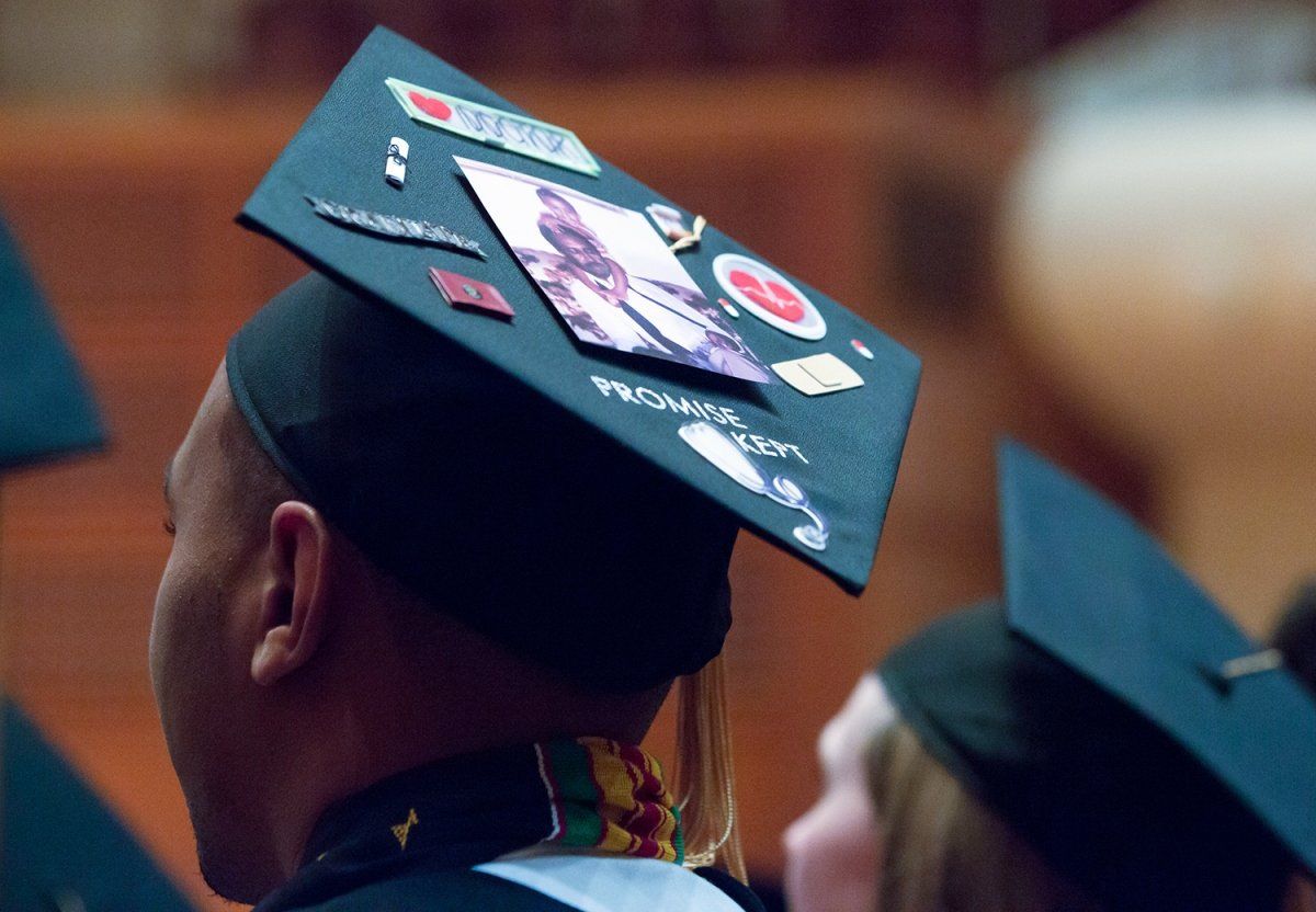 Student cap with words "promise kept" on it.