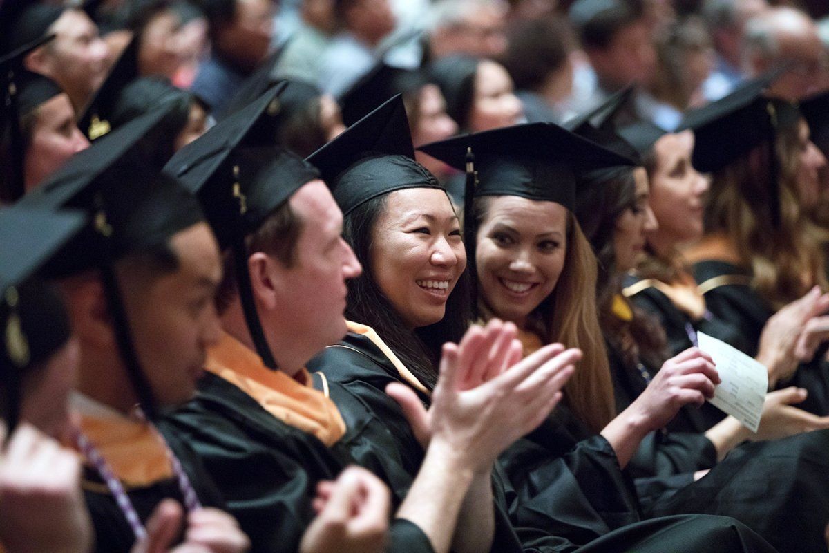 School of Nursing graduates clap during their commencement ceremony