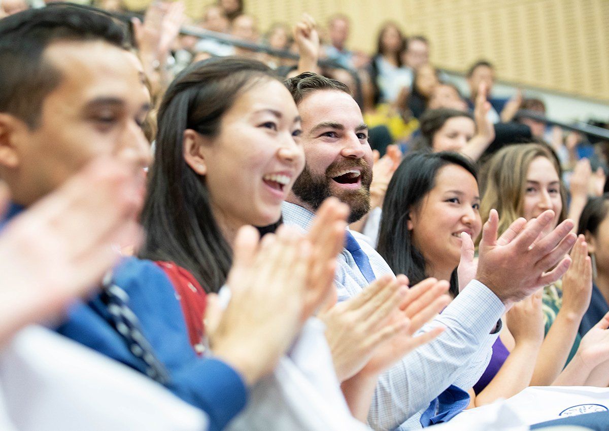 Incoming Physical Therapy program students Edward Hernandez, Tim Jannisse, Isabel Juan and Kayla Katzman, listen to a presentation during the white coat Ceremony