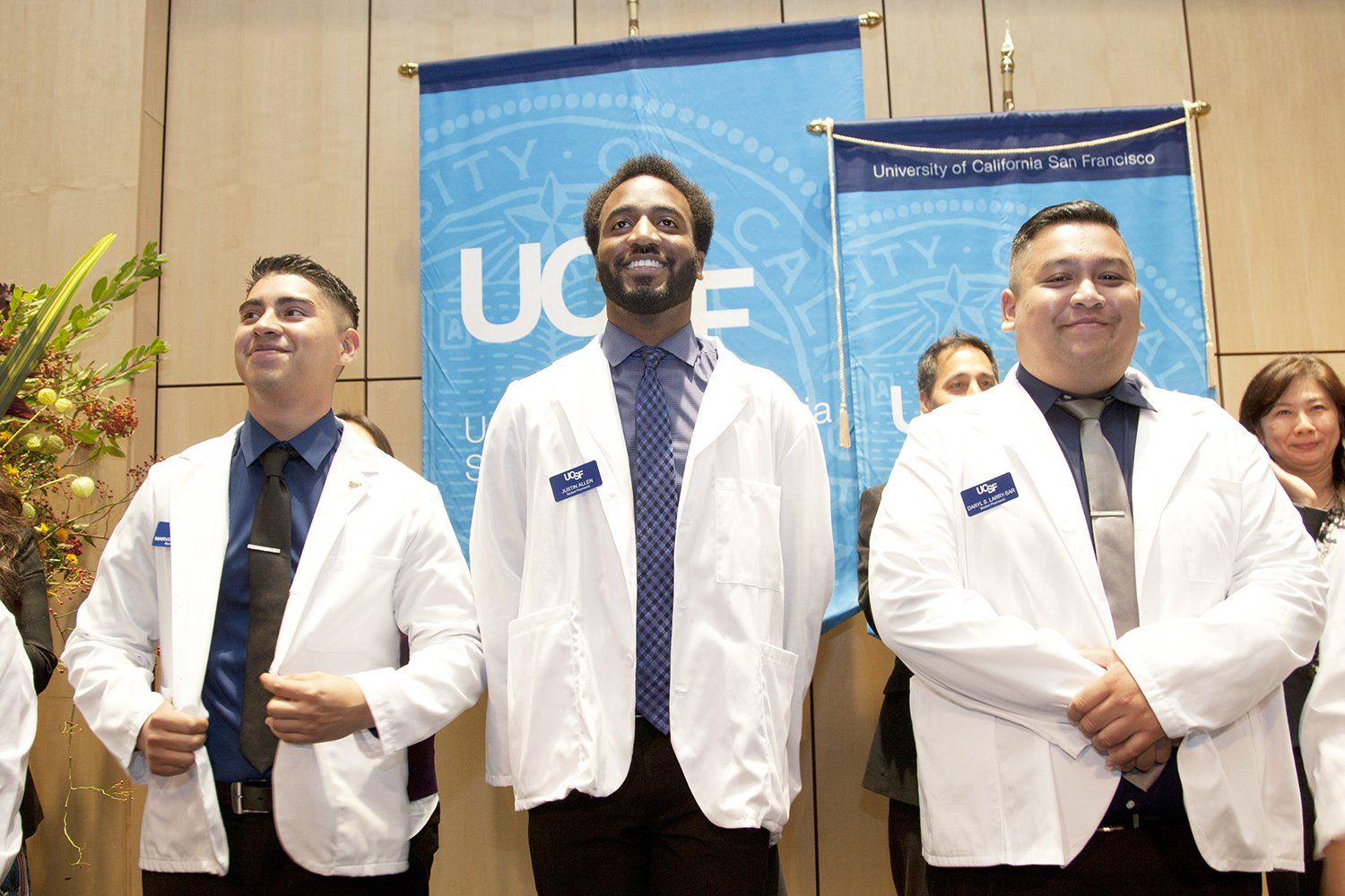 New School of Pharmacy students smile after receiving the white coats