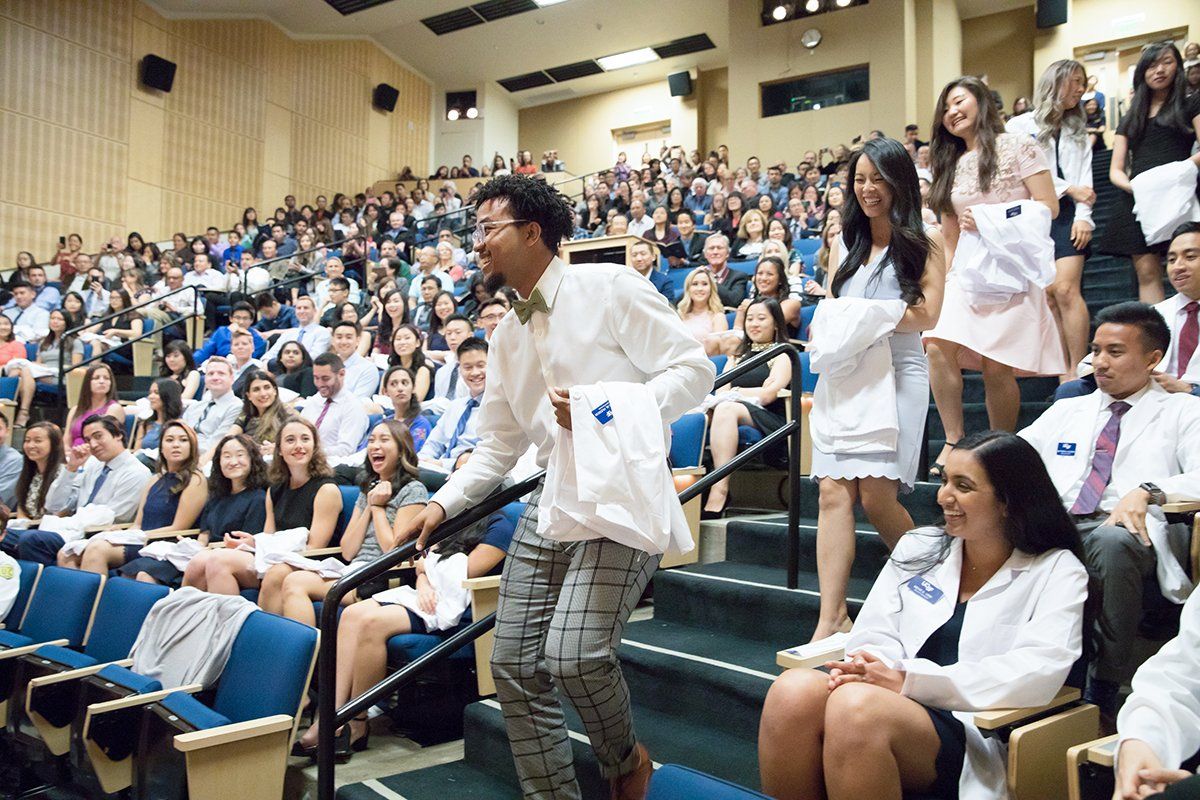Students make their way to the stage during the UCSF School of Pharmacy’s white coat ceremony