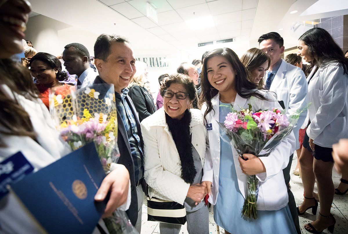 Francesca Alcala celebrates with her family after School of Pharmacy’s white coat ceremony