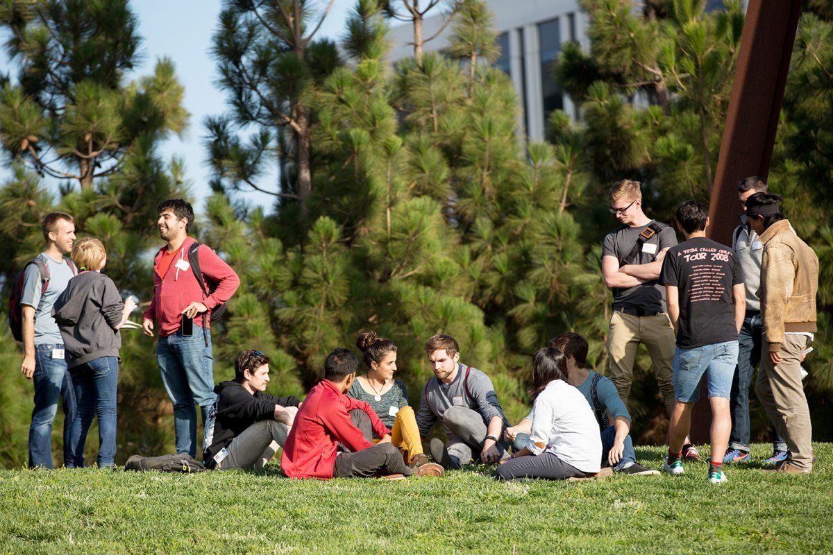 Students from the Biomedical Sciences Graduate Program relax on the grass in the Koret Quad