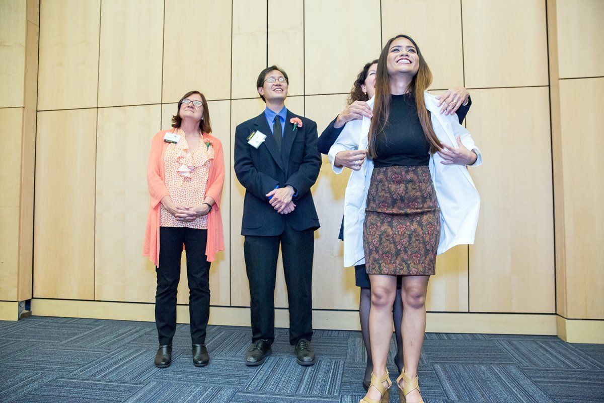 Kimberly Topp, PhD, PT, the Chair of the Department of Physical Therapy & Rehabilitation Science, cloaks new student Jalisha Napoles