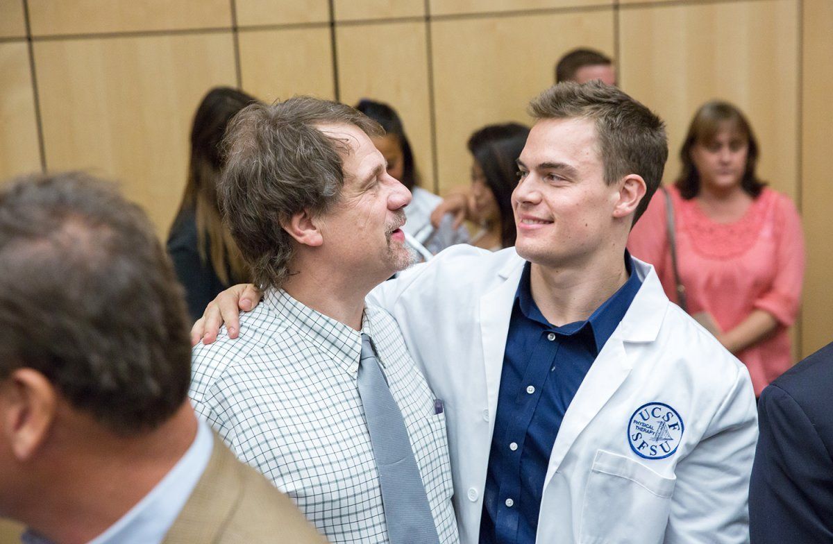 Mike Alzheimer a new student in the Physical Therapy Graduate Program, celebrates after the White Coat Ceremony