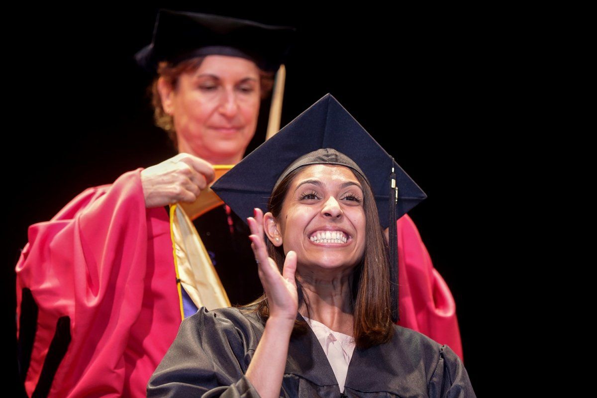 Sonya Chalaka is is hooded by Elizabeth Watkins, PhD