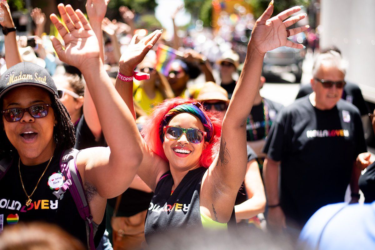 Evolve Benton, MA, MFA, and her partner Kiara Lee celebrate at the San Francisco LGBT Pride Parade