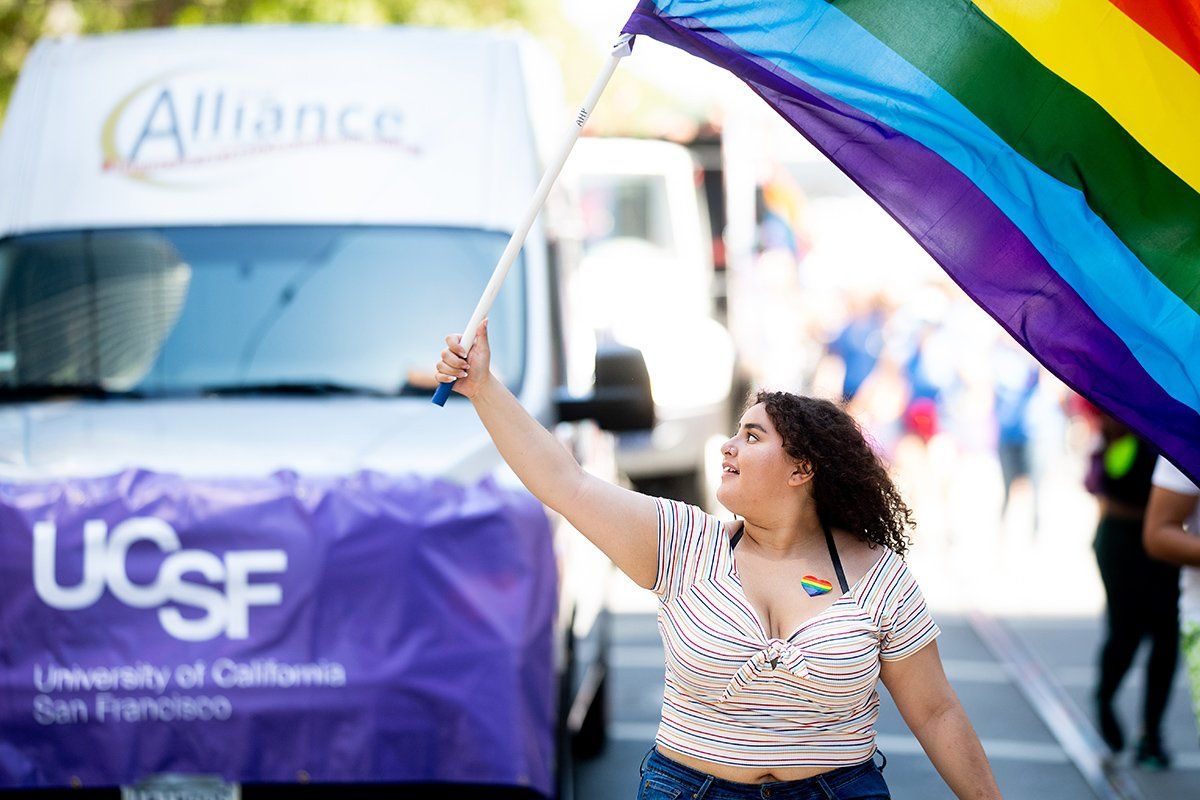 Woman waving a rainbow flag