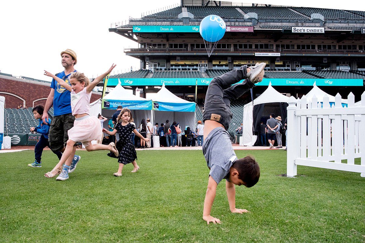 Young boy does a handstand on the grass