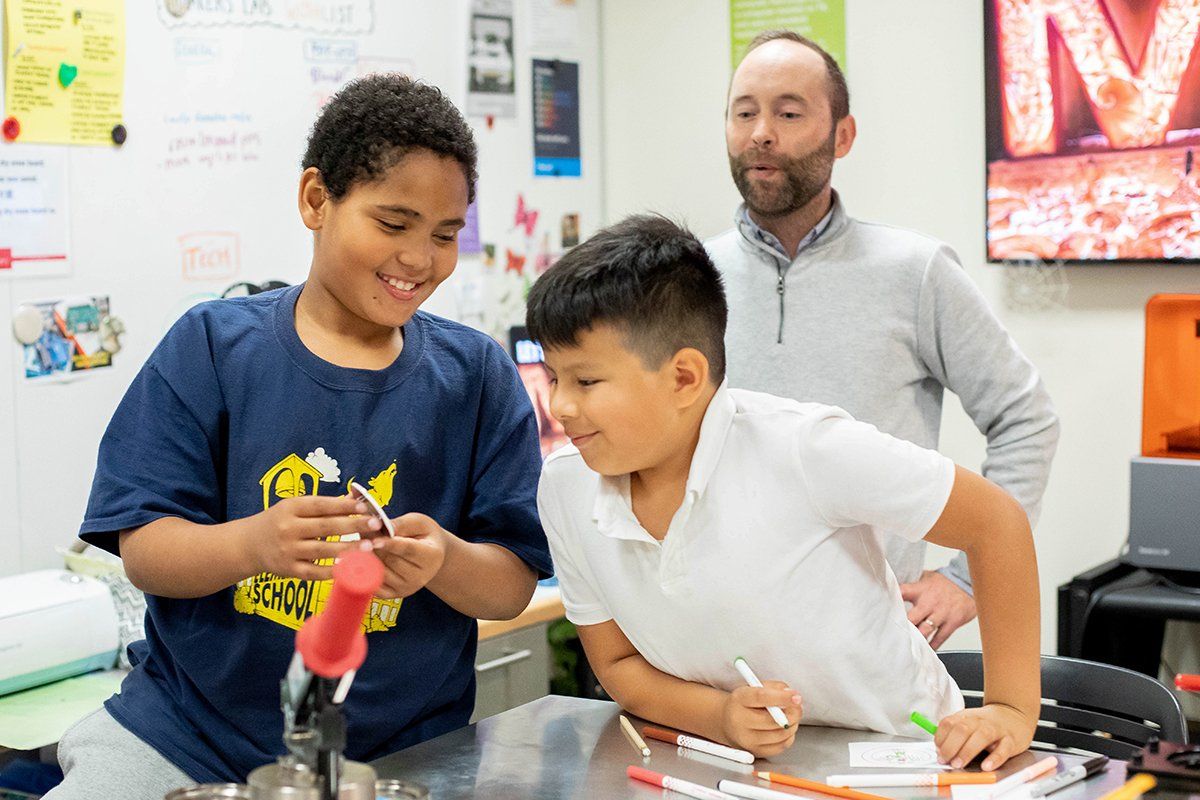 Two boys at the desk during 3D printing class