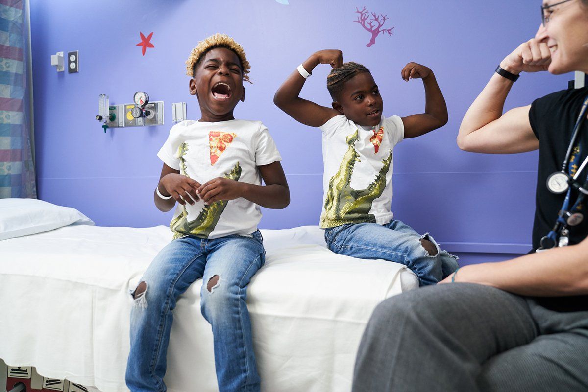 Twin brothers, Tylee and Taleeke, 6, are examined by their doctor Anne Marsh, MD
