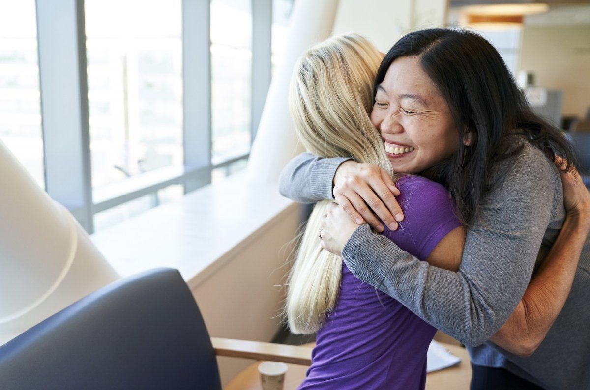 Sue Yom,MD, PhD embraces a patient.