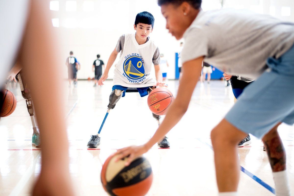 Zach Nazareno, 11, dribbles basketball during the UCSF Amputee Comprehensive Training