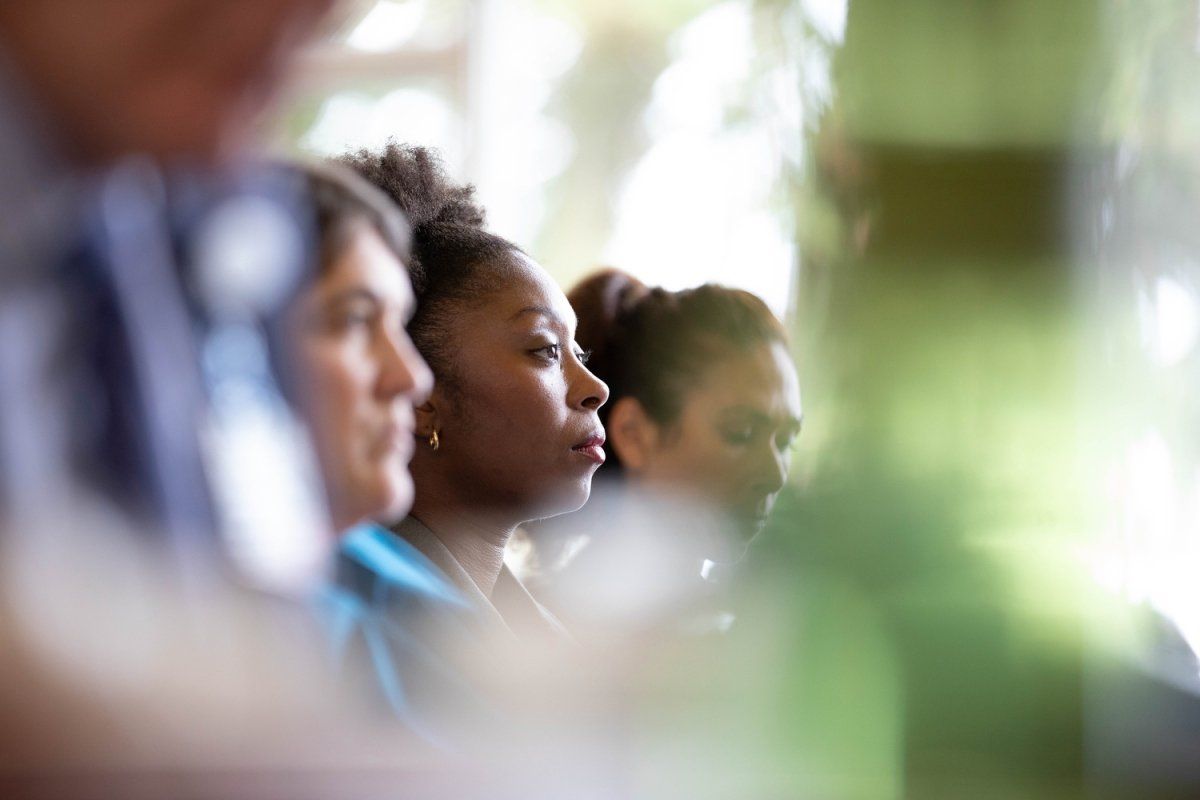 A group of people listening to a presentation