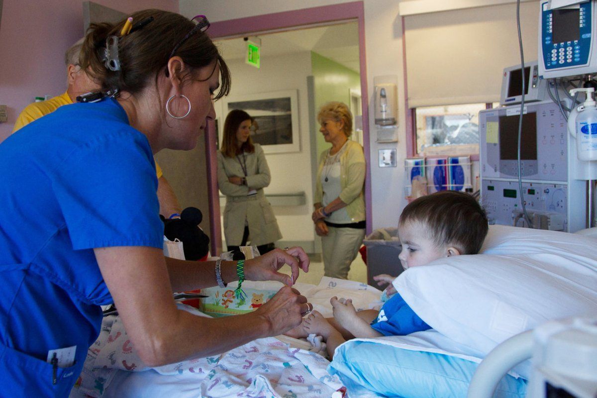 nurse attending to a child in a hospital room