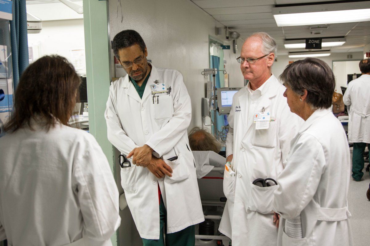 a group of four medical specialists having a conversation