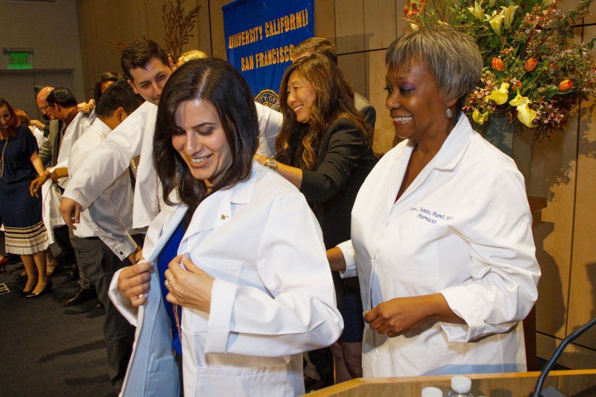 a woman receiving her white coat
