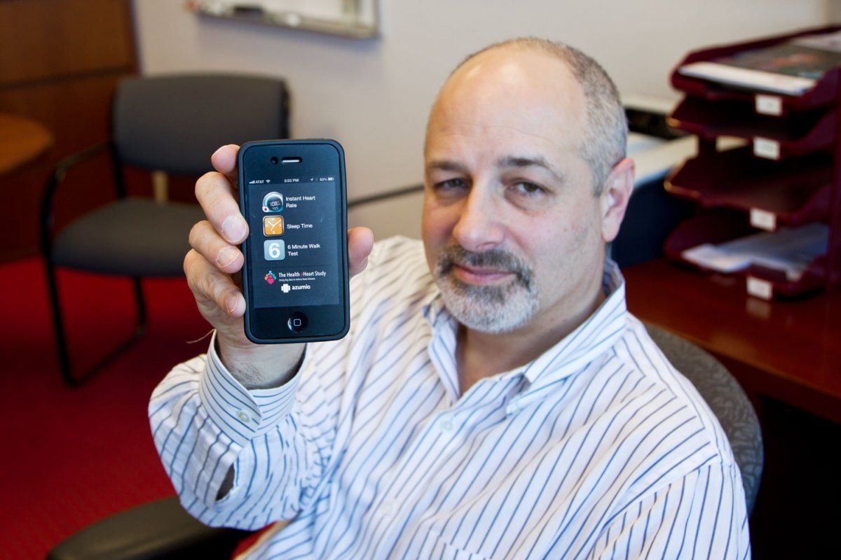 Jeffrey Olgin, MD holding a smartphone