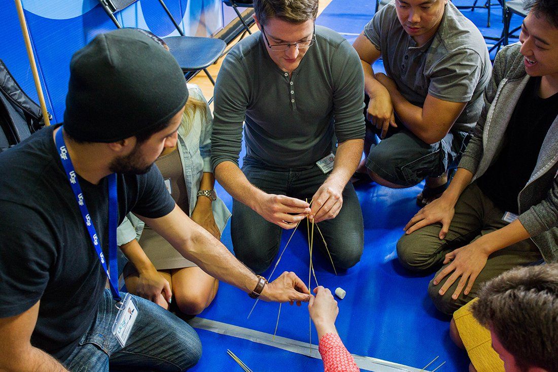 Students building a spaghetti tower for a team-building activity