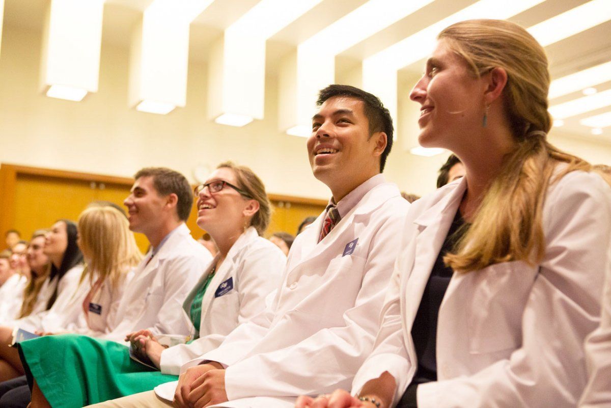 students seating at the white coat ceremony