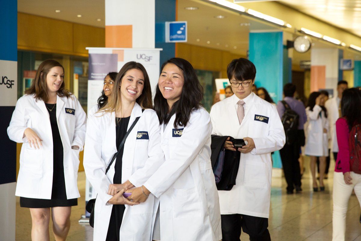 two students pose for a photo after the UCSF School of Dentistry White Coat Ceremony