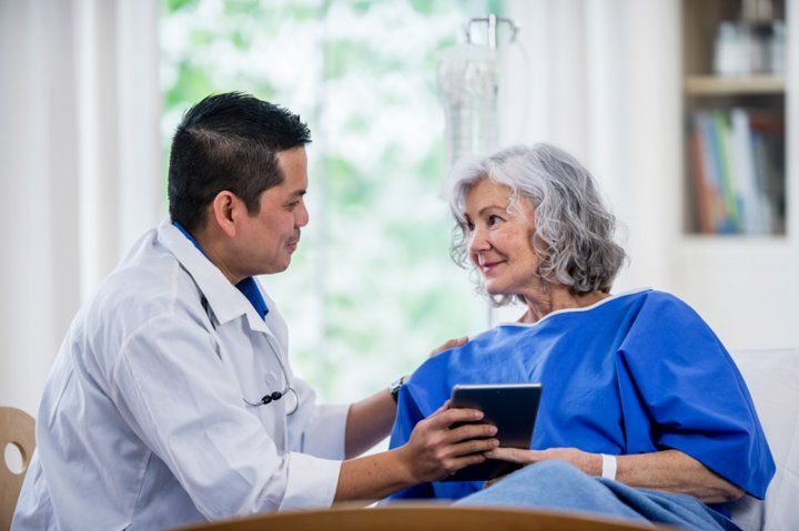 Doctor talking to patient, senior woman