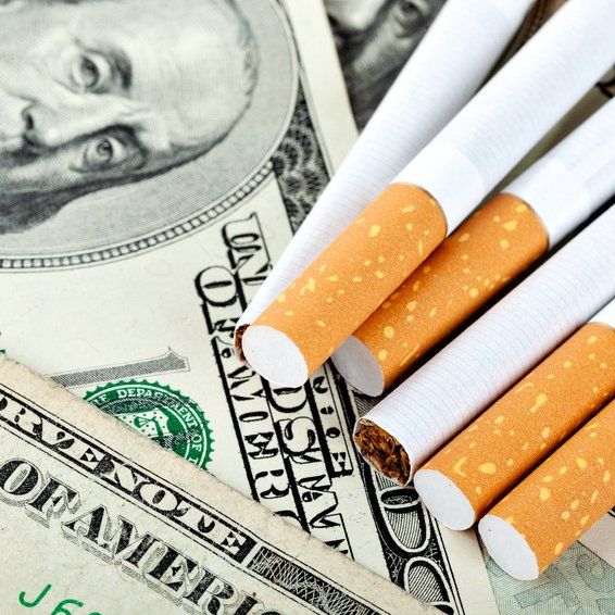 Cigarettes resting on money