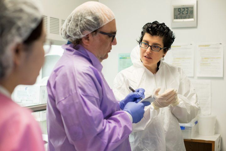 People talking in a lab setting, Lea Grinberg and Josh Kornbluth