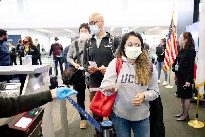 doctors line up to board a plane at San Francisco International Airport
