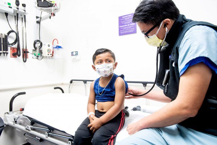 doctor examines pediatric patient in the emergency department