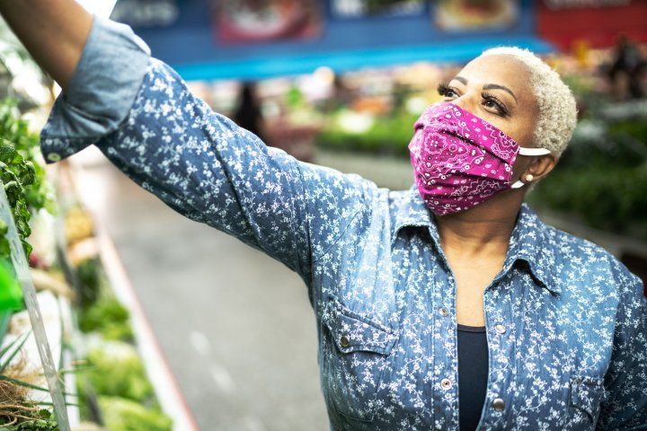 Woman wearing a cloth face mask in a grocery store