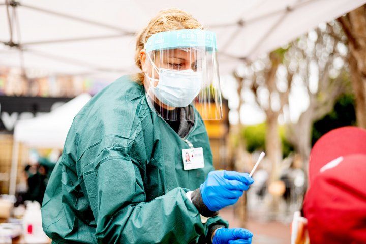 nurse administers a COVID test