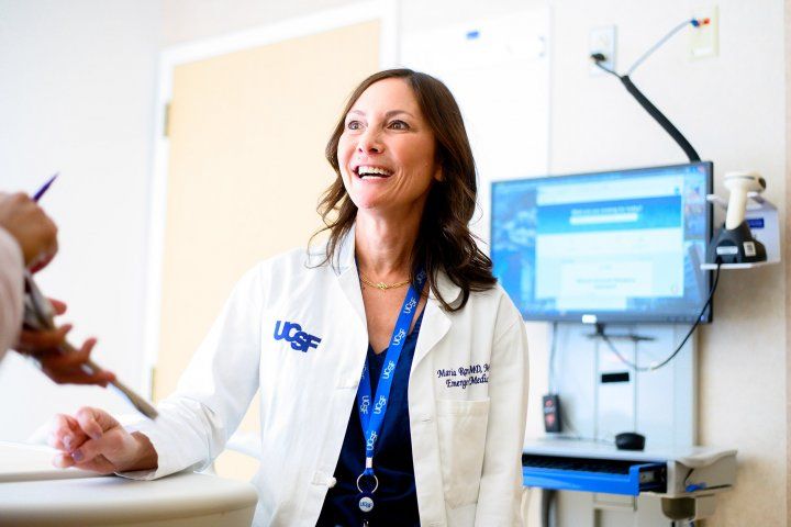 Maria Raven talks to another person in a hospital room