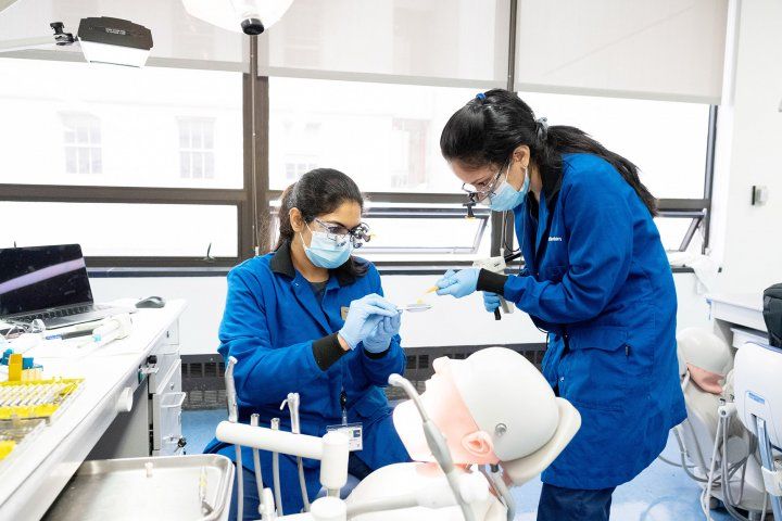 two dentistry students work in the clinic
