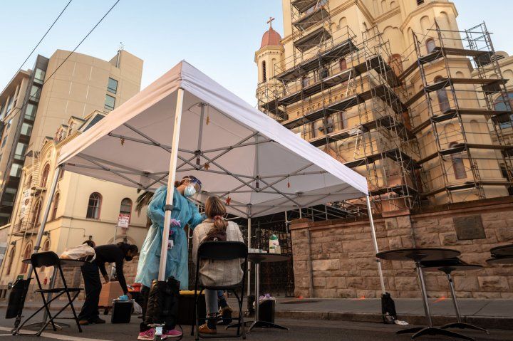 A person getting a nose swab in tent