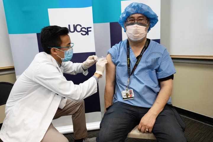 man receives a COVID-19 vaccination shot