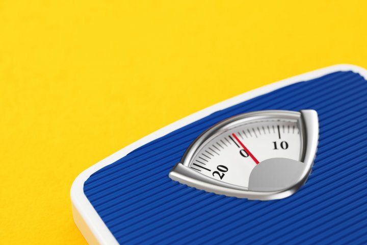 Blue bathroom scale on yellow background