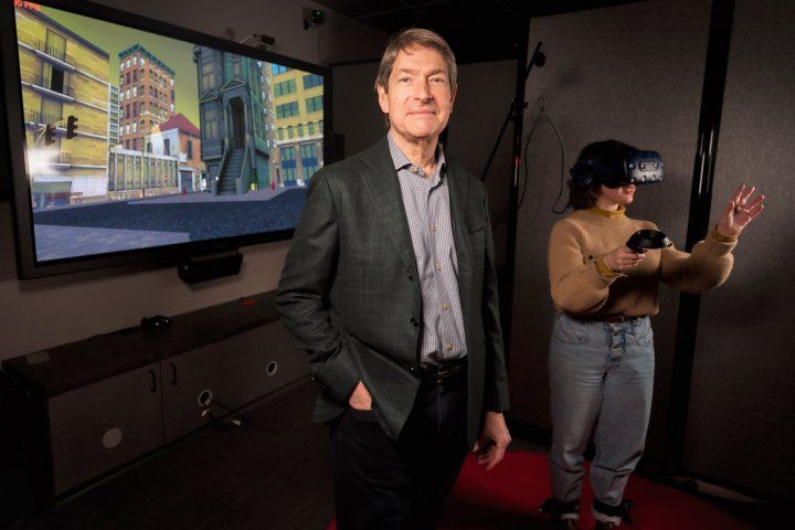 Peter Wais stands in front of a person using a virtual reality system