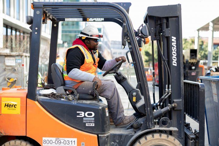 construction worker drives a forklift