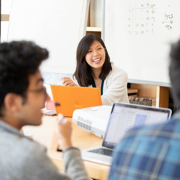 A student laughs with her fellow UCSFers during a meeting in Rock Hall