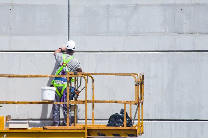 construction worker works with paint 