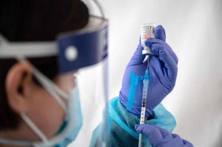 nurse prepares a COVID-19 vaccine shot