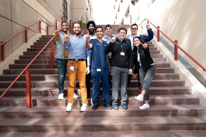 Eight First Gen Scholarship recipients pose for a photo on stairs at Parnassus campus