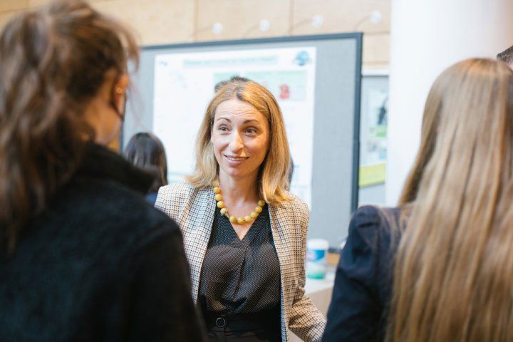 Natalia Jura speaks with guests at the Byers Lecture