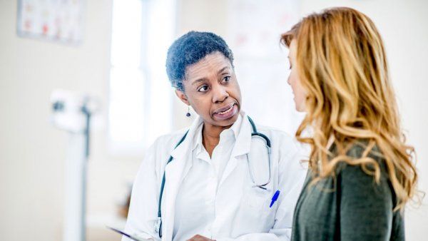 Physician consulting with female patient