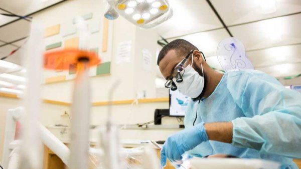 Dental student examines patient. 