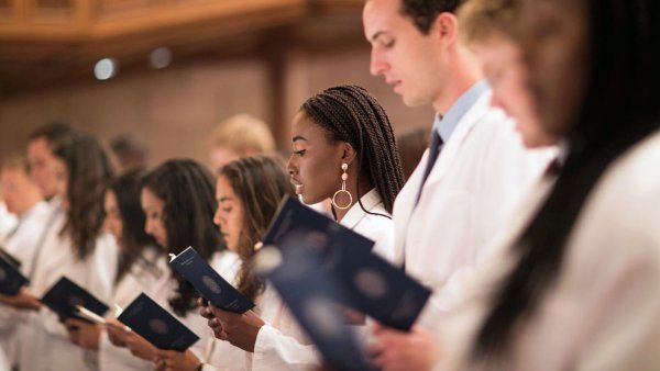 Med students taking oath during white coat ceremony